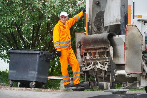 Workers using PPE and safe lifting equipment